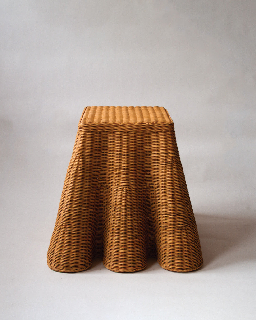 Scalloped rattan side table
